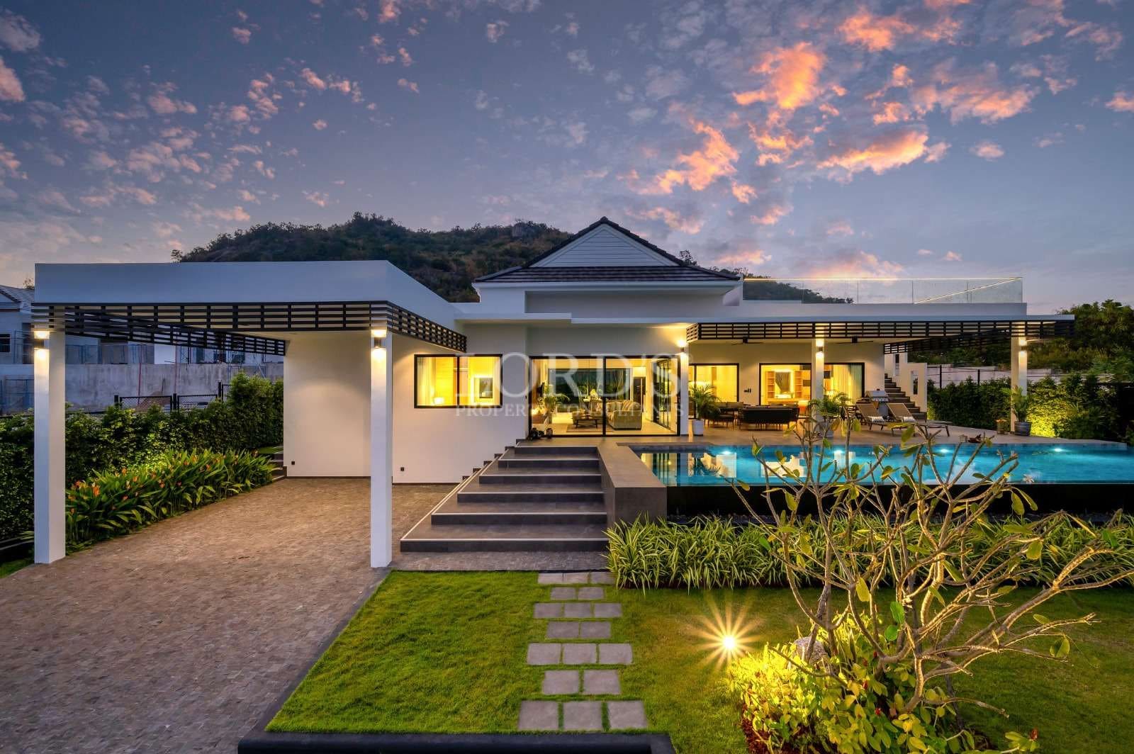 Modern villa with sunset backdrop