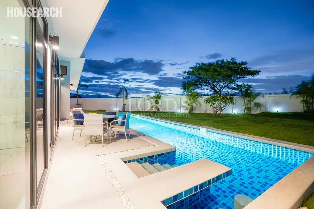 Modern home with pool at dusk