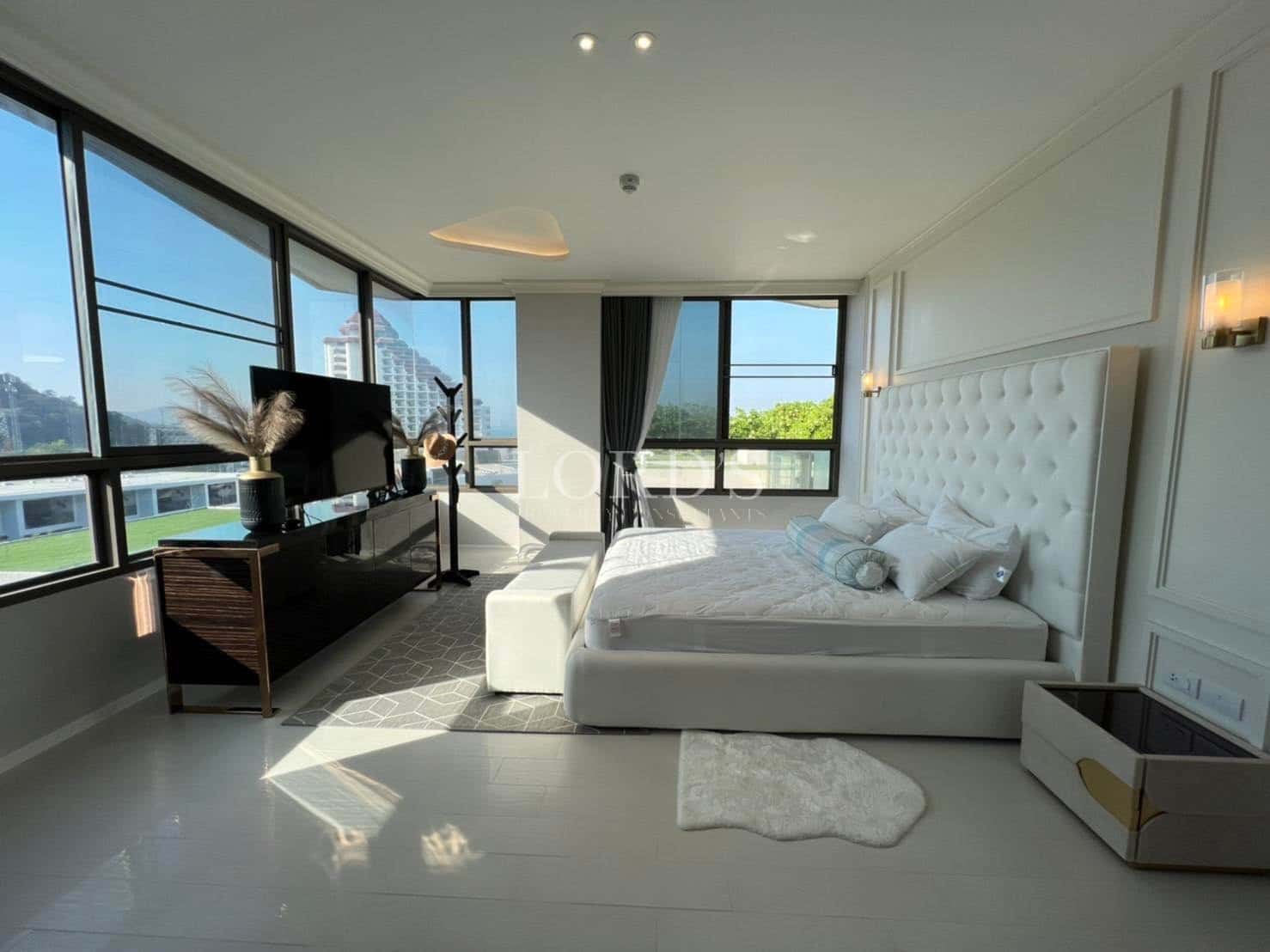 Modern bedroom with large windows